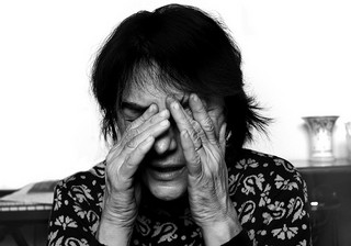 woman rubbing her eyes