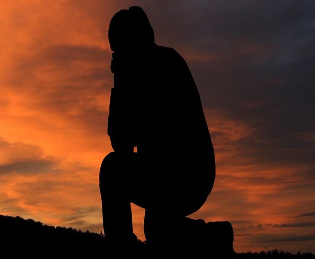 man bowing on his knee